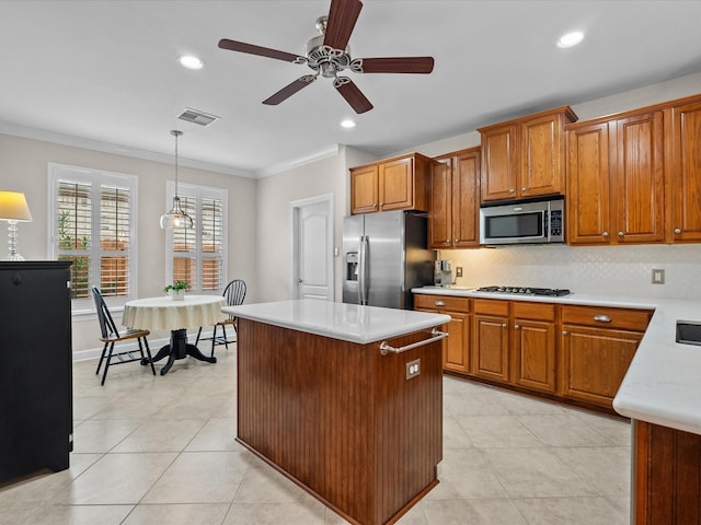 kitchen featuring stainless steel appliances, brown cabinets, visible vents, and light countertops