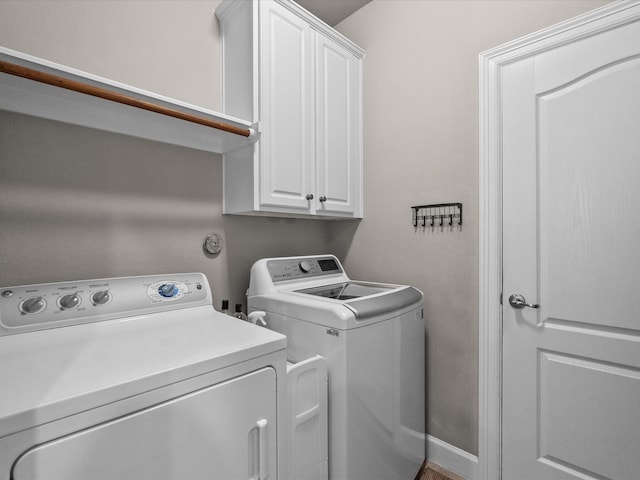 washroom featuring cabinet space and washing machine and dryer