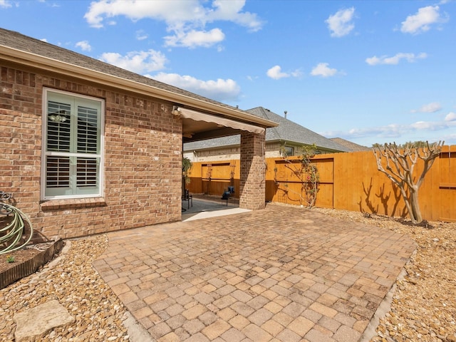 view of patio featuring fence