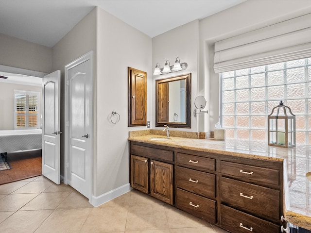 bathroom featuring tile patterned flooring, vanity, and baseboards