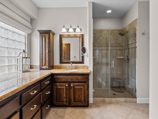 bathroom featuring vanity, a shower stall, and tile patterned flooring