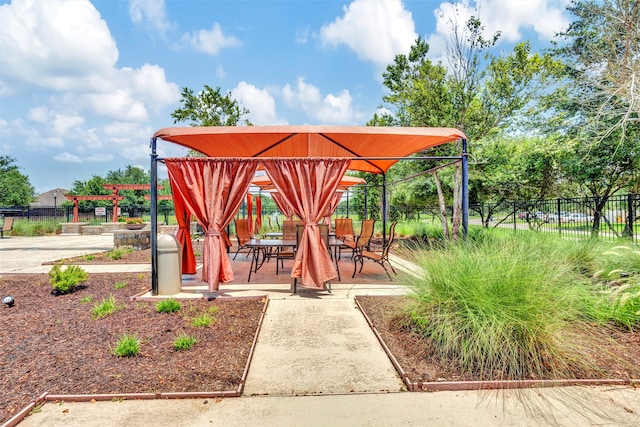 view of home's community with a gazebo and fence