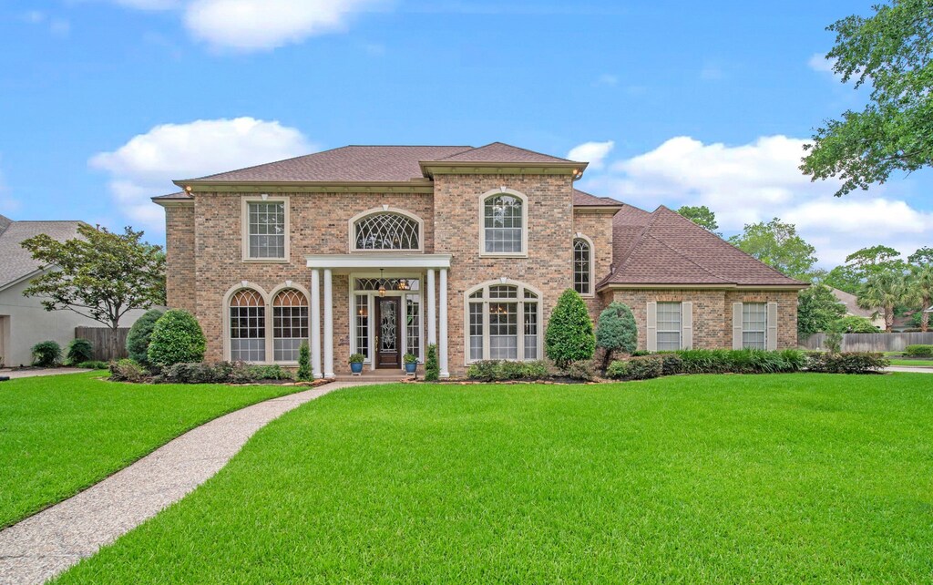9702 Kepler Mcvey Ct, Spring, TX 77379 - view of front of house with a front lawn, fence, and brick siding