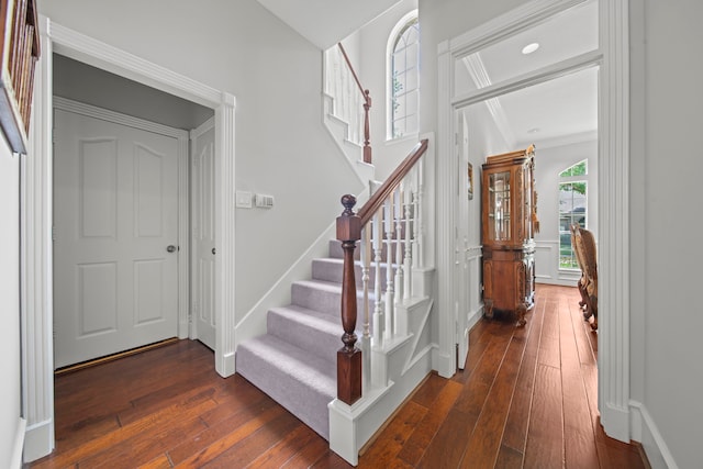 stairs with baseboards and hardwood / wood-style flooring