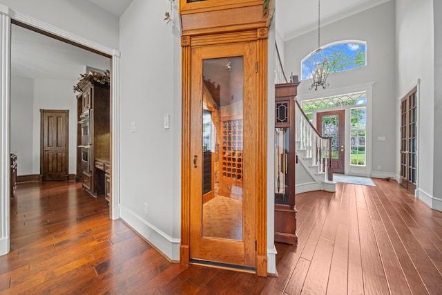 hall with stairway, dark wood-type flooring, and baseboards