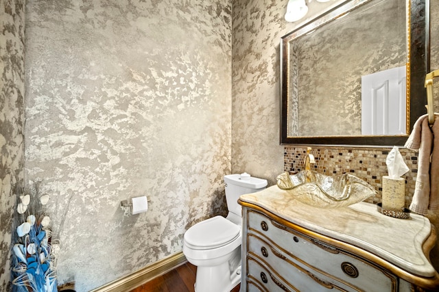 bathroom with vanity, toilet, and wood finished floors