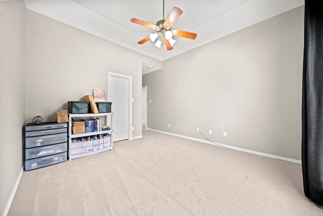 interior space featuring baseboards, ceiling fan, and carpet flooring