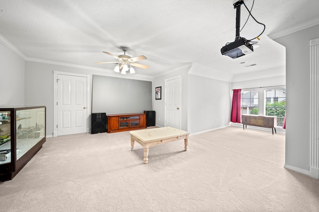 carpeted living room with baseboards, a textured ceiling, ornamental molding, and a ceiling fan