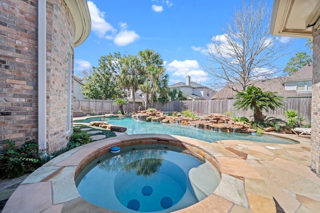 view of pool with a fenced in pool, an in ground hot tub, a fenced backyard, and a patio area