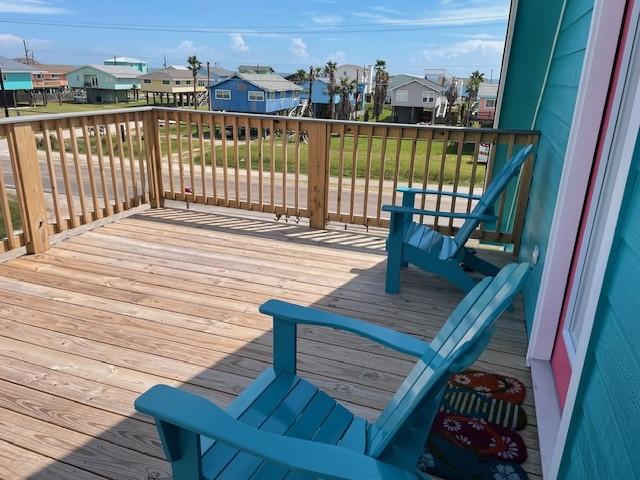 203 Sea Oats Dr, Surfside Beach, TX 77541 - wooden deck featuring a residential view