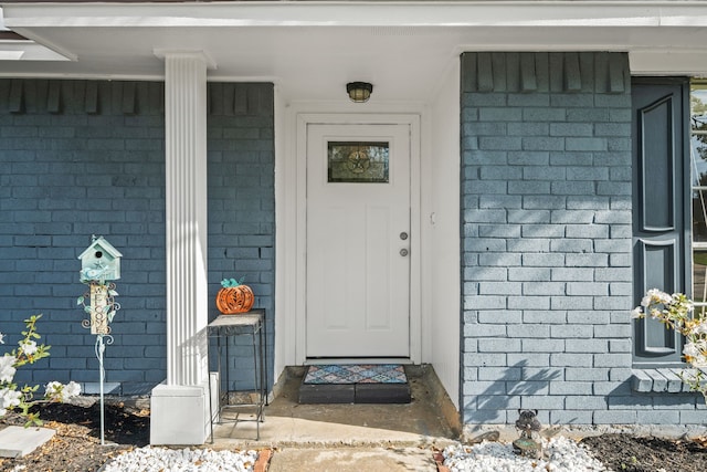 doorway to property with brick siding