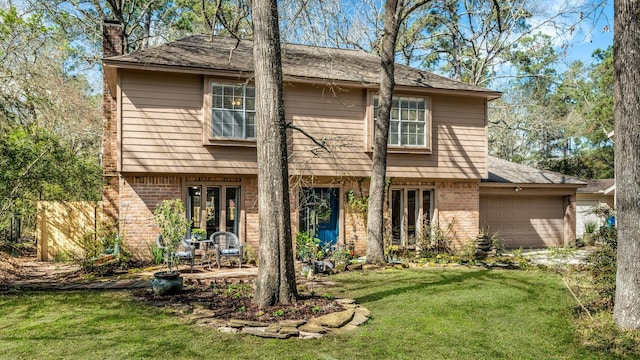 view of front facade featuring a garage, brick siding, a chimney, and a front yard