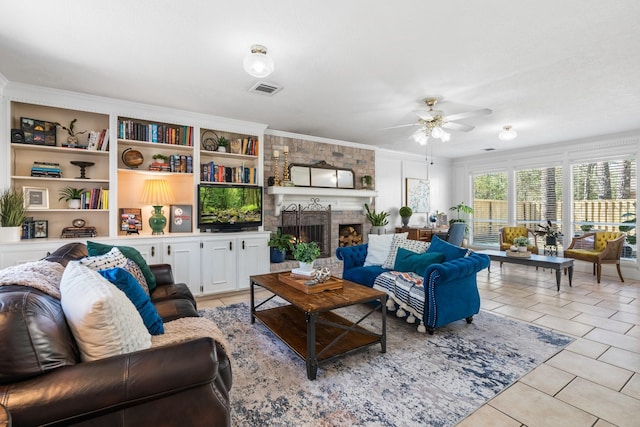 living room featuring light tile patterned floors, visible vents, ceiling fan, ornamental molding, and a fireplace