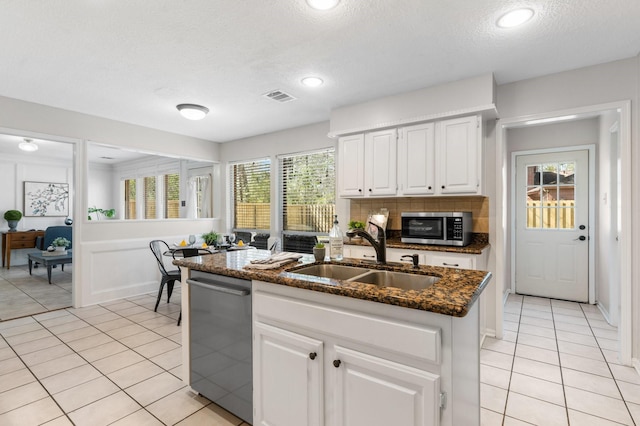 kitchen featuring white cabinetry, visible vents, appliances with stainless steel finishes, and a sink