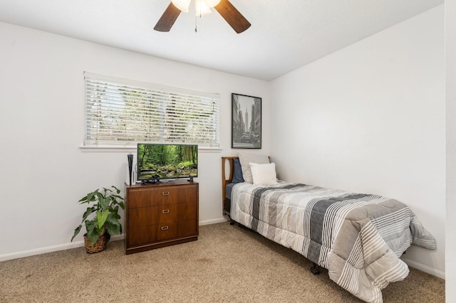 bedroom with baseboards, a ceiling fan, and light colored carpet