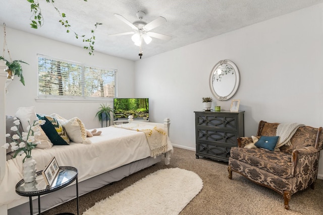 bedroom with carpet floors, a ceiling fan, baseboards, and a textured ceiling