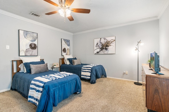 carpeted bedroom featuring baseboards, visible vents, a ceiling fan, and crown molding