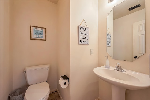 bathroom with a sink, visible vents, and toilet