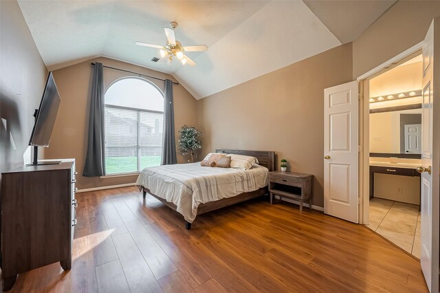 bedroom featuring lofted ceiling, wood finished floors, and baseboards