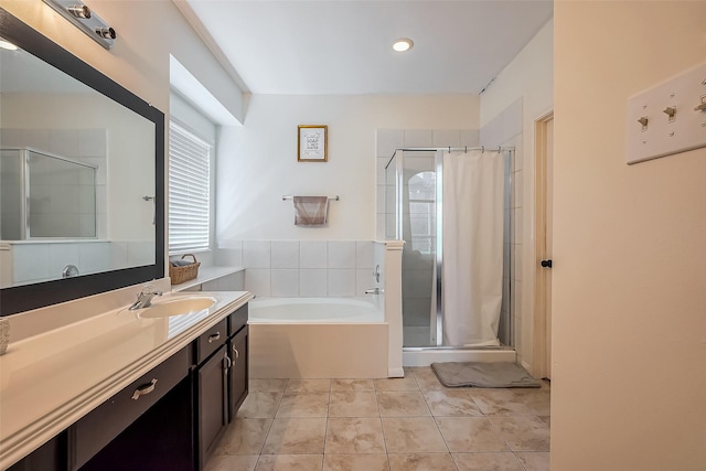 full bathroom featuring vanity, a garden tub, a stall shower, and tile patterned flooring