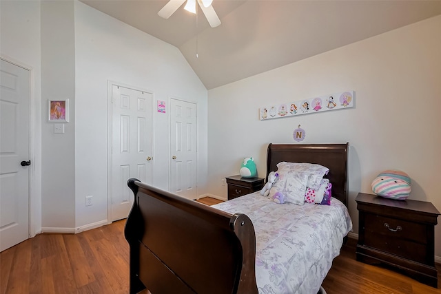 bedroom with ceiling fan, baseboards, lofted ceiling, and wood finished floors