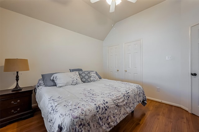 bedroom featuring dark wood finished floors, lofted ceiling, a ceiling fan, and baseboards