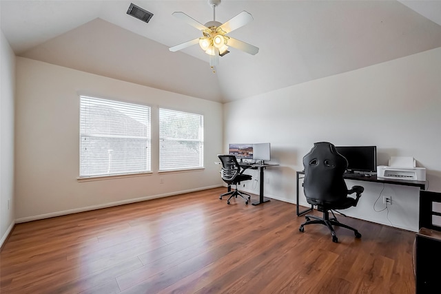 home office with visible vents, baseboards, lofted ceiling, wood finished floors, and a ceiling fan