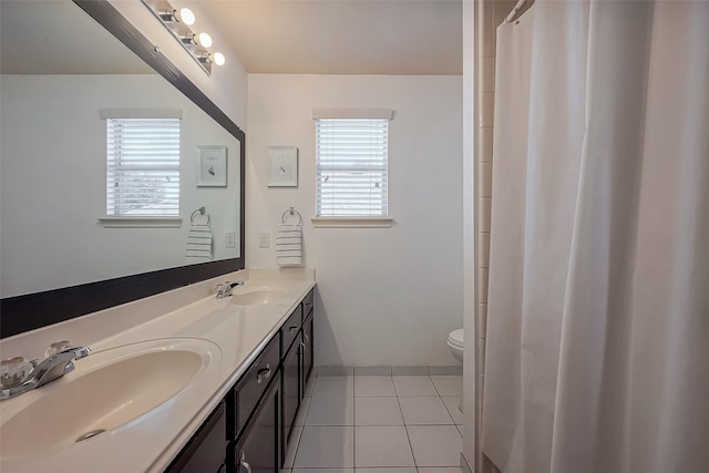 full bathroom with a sink, a healthy amount of sunlight, and tile patterned flooring