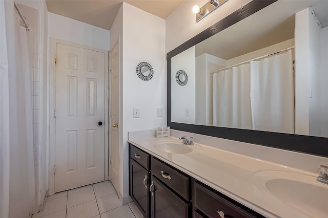 bathroom with tile patterned floors, double vanity, and a sink