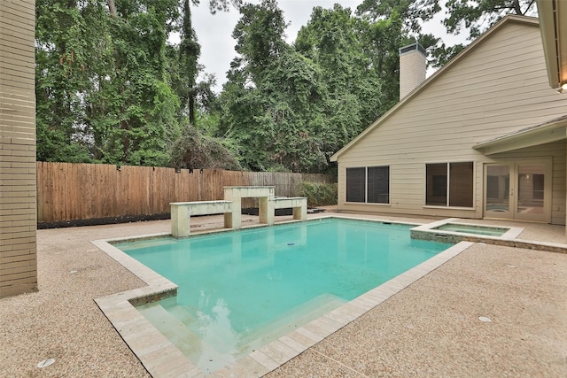 view of pool with an in ground hot tub, a patio area, a fenced backyard, and a fenced in pool