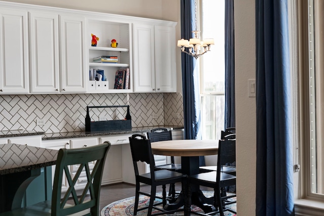 dining area featuring wood finished floors and a notable chandelier