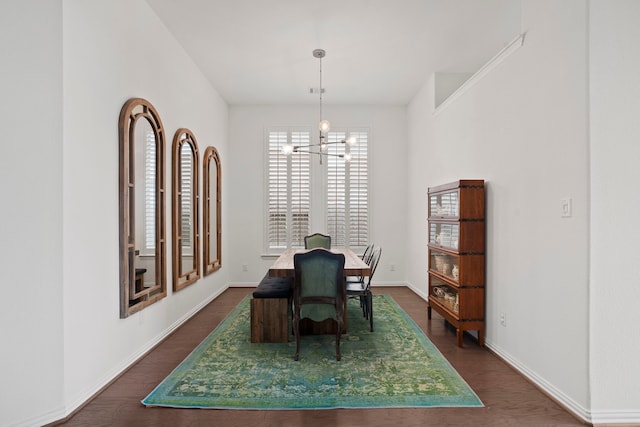 dining area with an inviting chandelier, baseboards, and dark wood finished floors