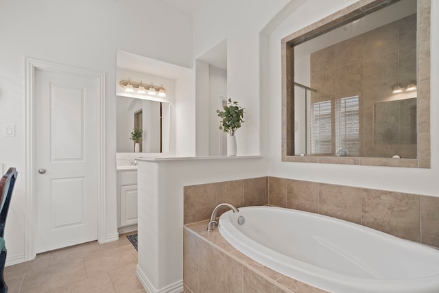 full bath featuring a garden tub, tile patterned floors, tiled shower, and vanity