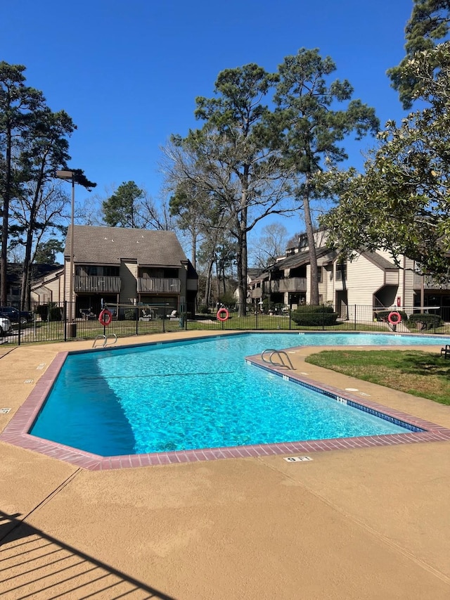 community pool featuring fence