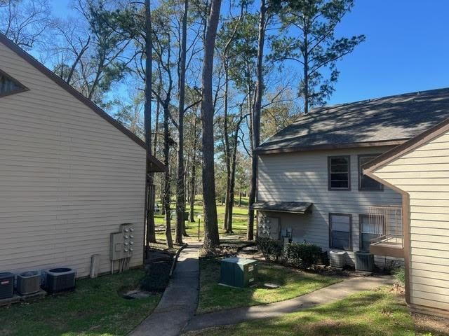 view of side of home with central AC