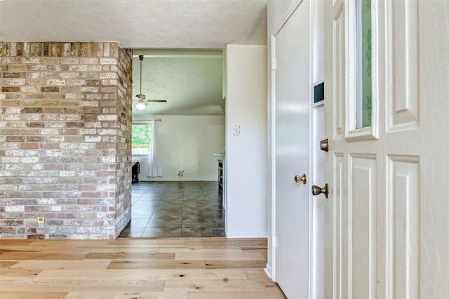 hallway featuring a textured ceiling and wood finished floors