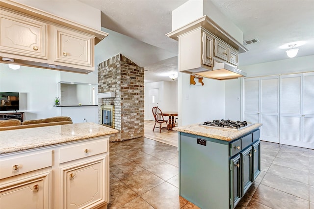 kitchen featuring open floor plan, visible vents, stainless steel gas cooktop, and light tile patterned floors