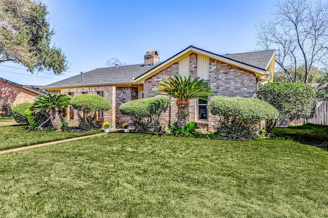 view of front of property featuring roof with shingles, a chimney, and a front yard