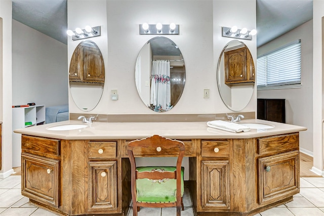 bathroom featuring double vanity, tile patterned flooring, and a sink