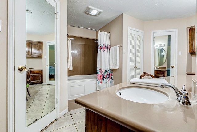 full bath featuring visible vents, a shower with shower curtain, vanity, a textured ceiling, and tile patterned floors