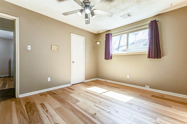 unfurnished bedroom featuring light wood-style floors, baseboards, visible vents, and a ceiling fan