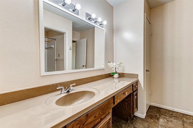 bathroom featuring baseboards and vanity