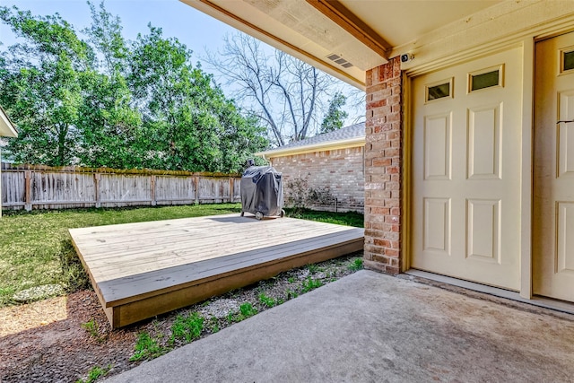 wooden terrace with fence and grilling area