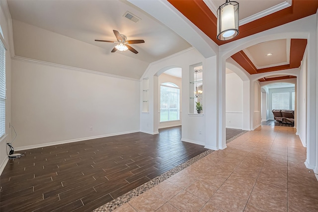 10714 Barker Lake Ct, Cypress, TX 77433 - spare room with a ceiling fan, healthy amount of natural light, baseboards, crown molding, and wood finished floors
