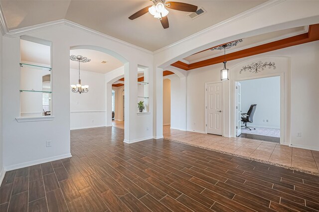 unfurnished room with arched walkways, crown molding, visible vents, wood tiled floor, and ceiling fan with notable chandelier