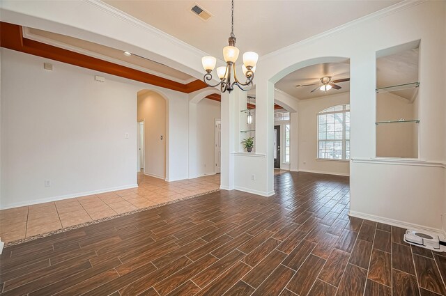 empty room featuring arched walkways, ceiling fan with notable chandelier, visible vents, and wood tiled floor