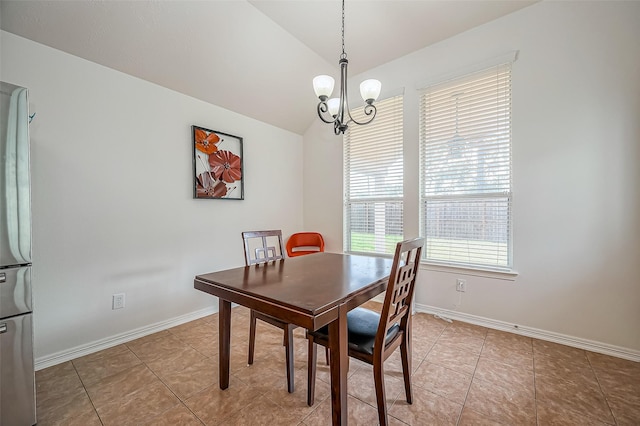 dining area with vaulted ceiling, light tile patterned flooring, a notable chandelier, and baseboards