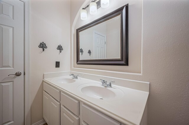 bathroom featuring double vanity and a sink