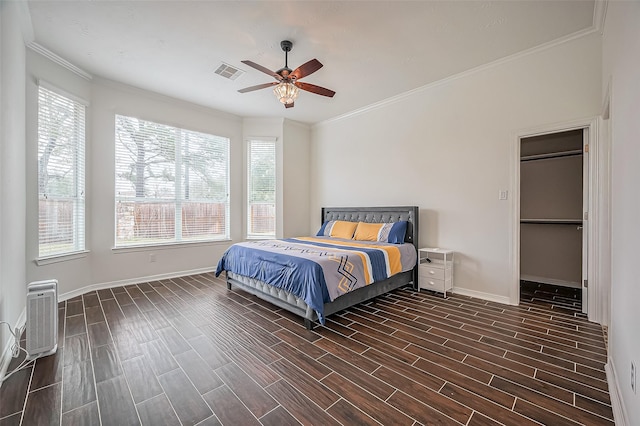 10714 Barker Lake Ct, Cypress, TX 77433 - bedroom with dark wood-type flooring, baseboards, crown molding, heating unit, and a ceiling fan
