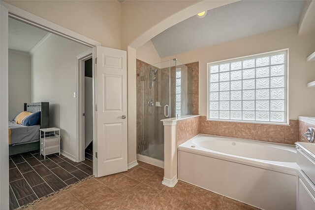 bathroom with a healthy amount of sunlight, a garden tub, a shower stall, and ensuite bath